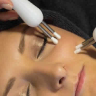 a woman receiving a luxurious facial treatment