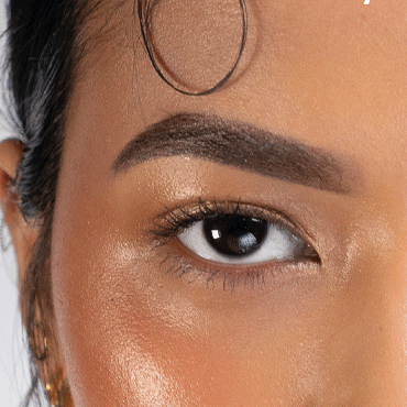 Close up of a woman of colour with styled dark brown eye brows

